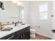 Powder bathroom features modern vanity with black fixtures, quartz countertop and wood-look tile floors at 9746 Sw 108Th Terrace Rd, Ocala, FL 34481