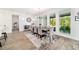 An open dining room features wood floors, an area rug, and views of a screened-in porch at 9746 Sw 108Th Terrace Rd, Ocala, FL 34481