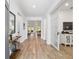 Bright foyer with wood floors, white walls, modern decor, and a view into the spacious living areas at 9746 Sw 108Th Terrace Rd, Ocala, FL 34481