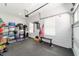 Organized garage space featuring gym equipment, ample storage, and natural light at 9746 Sw 108Th Terrace Rd, Ocala, FL 34481