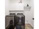 Functional laundry room equipped with modern washer and dryer units and ample storage space at 9746 Sw 108Th Terrace Rd, Ocala, FL 34481