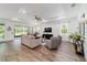 Airy living room with tray ceiling, natural light, stylish furnishings, and sliding glass doors to the lanai at 9746 Sw 108Th Terrace Rd, Ocala, FL 34481