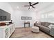 Comfortable living room showcasing wood-look tile floors, a plush couch, and a media center with ample storage at 9746 Sw 108Th Terrace Rd, Ocala, FL 34481