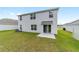 Spacious backyard with a well-maintained lawn and a sliding glass door for easy access at 11205 Se 69Th Ter, Belleview, FL 34420