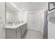 Bathroom featuring double sinks with white counters, gray cabinets, and a shower with gray curtain at 11205 Se 69Th Ter, Belleview, FL 34420
