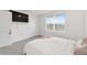 Comfortable bedroom with carpeted floors, neutral walls, and a window with blinds for natural light at 11205 Se 69Th Ter, Belleview, FL 34420