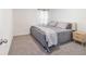 Serene bedroom features soft gray bedding, carpet floors, and natural light at 11205 Se 69Th Ter, Belleview, FL 34420