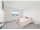 Cozy bedroom with a neutral color scheme, carpeted floor and a window that provides natural light at 11205 Se 69Th Ter, Belleview, FL 34420