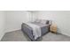 Serene bedroom features soft gray bedding, carpet floors, and natural light at 11205 Se 69Th Ter, Belleview, FL 34420