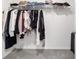 Walk-in closet featuring carpet flooring and shelving with hanging clothes and folded clothes at 11205 Se 69Th Ter, Belleview, FL 34420