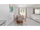 Cozy dining area with a round table, seating for four, and bright natural light at 11205 Se 69Th Ter, Belleview, FL 34420