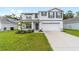 Charming two-story home featuring a well-manicured lawn and an attached two-car garage at 11205 Se 69Th Ter, Belleview, FL 34420