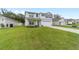 Charming two-story home featuring a well-manicured lawn and an attached two-car garage at 11205 Se 69Th Ter, Belleview, FL 34420