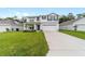 Charming two-story home featuring a well-manicured lawn and an attached two-car garage at 11205 Se 69Th Ter, Belleview, FL 34420