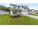 Charming two-story home featuring a well-manicured lawn and an attached two-car garage at 11205 Se 69Th Ter, Belleview, FL 34420
