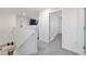 Upstairs hallway with neutral carpet, leading to bedrooms, a full bathroom and an open living area at 11205 Se 69Th Ter, Belleview, FL 34420