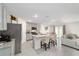 Modern kitchen with an island and a living area with natural light at 11205 Se 69Th Ter, Belleview, FL 34420