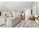 Bright, open kitchen featuring stainless steel appliances and gray cabinets with recessed lights at 11205 Se 69Th Ter, Belleview, FL 34420