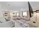 Large living room features comfortable sofas, a view to the kitchen, and lots of natural light at 11205 Se 69Th Ter, Belleview, FL 34420