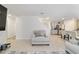 Bright living area features an armchair, tile flooring, and seamlessly flows into an open kitchen at 11205 Se 69Th Ter, Belleview, FL 34420