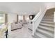 Cozy living area with a stairway, neutral decor, and ample seating at 11205 Se 69Th Ter, Belleview, FL 34420