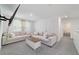 Comfortable living room with plush sofas, a stylish coffee table, and a mounted TV, offering a cozy space at 11205 Se 69Th Ter, Belleview, FL 34420