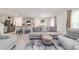 Spacious living room adjacent to the kitchen, furnished with comfortable seating and stylish decor at 11205 Se 69Th Ter, Belleview, FL 34420
