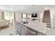 Open-concept living room with a breakfast nook, stainless steel appliances and staircase access to the second floor at 11205 Se 69Th Ter, Belleview, FL 34420