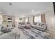 Open concept living room featuring comfortable seating and direct access to the kitchen and dining area at 11205 Se 69Th Ter, Belleview, FL 34420
