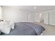 Comfortable main bedroom features neutral decor, and multiple doors at 11205 Se 69Th Ter, Belleview, FL 34420