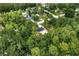 Aerial view of homesite with new construction featuring dark roof and wooded setting at 11506 Nw 20Th St, Ocala, FL 34482