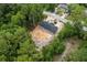 New construction home with dark roof nestled in a wooded lot, aerial view at 11506 Nw 20Th St, Ocala, FL 34482