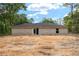 The backyard has a newly constructed home with sliding glass doors and a large window at 11506 Nw 20Th St, Ocala, FL 34482