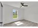 Bright bedroom with hardwood floors, a ceiling fan, and a large window offering natural light at 11506 Nw 20Th St, Ocala, FL 34482