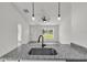 Open-concept kitchen featuring granite countertops, stainless steel sink, and views into the living area at 11506 Nw 20Th St, Ocala, FL 34482