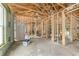 Spacious, unfinished living room featuring exposed wood beams and framing, ready for customization at 11506 Nw 20Th St, Ocala, FL 34482