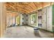 Unfinished living room showcasing exposed framing, and a large window with natural light at 11506 Nw 20Th St, Ocala, FL 34482