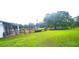 Expansive backyard featuring lush green grass and black fencing for horses at 12524 Sw 109Th Pl, Dunnellon, FL 34432