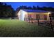 Exterior view of a barn featuring multiple doors and fencing in a grassy area at 12524 Sw 109Th Pl, Dunnellon, FL 34432