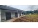 A horse barn exterior featuring multiple stalls and an adjacent paddock at 12524 Sw 109Th Pl, Dunnellon, FL 34432