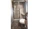 A bathroom with a glass-enclosed shower featuring a built-in seat and a toilet at 12524 Sw 109Th Pl, Dunnellon, FL 34432