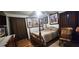 The bedroom has a bed, rocking chair, and hardwood floors with dark curtains at 12524 Sw 109Th Pl, Dunnellon, FL 34432
