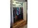 This bedroom has a closet with sliding doors, loaded with hanging clothes and suitcases on the floor at 12524 Sw 109Th Pl, Dunnellon, FL 34432