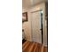 This walk-in closet has a white door and wood floors, with ample shelving and clothes racks for storage at 12524 Sw 109Th Pl, Dunnellon, FL 34432