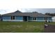 Charming single-story home with blue exterior, well-maintained lawn, and classic windows at 12524 Sw 109Th Pl, Dunnellon, FL 34432