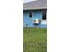 Exterior side view of home with an external AC unit and green lawn at 12524 Sw 109Th Pl, Dunnellon, FL 34432