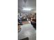 Unfinished garage with overhead lighting, storage shelves, and concrete floor at 12524 Sw 109Th Pl, Dunnellon, FL 34432