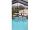 Spa with tiled trim connected to an enclosed swimming pool at 12524 Sw 109Th Pl, Dunnellon, FL 34432