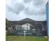 Relaxing screened-in pool area with seating and view of surrounding structures at 12524 Sw 109Th Pl, Dunnellon, FL 34432