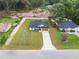 Aerial view of the property highlights its expansive lawn and peaceful suburban setting at 13803 Se 44Th Ave, Summerfield, FL 34491